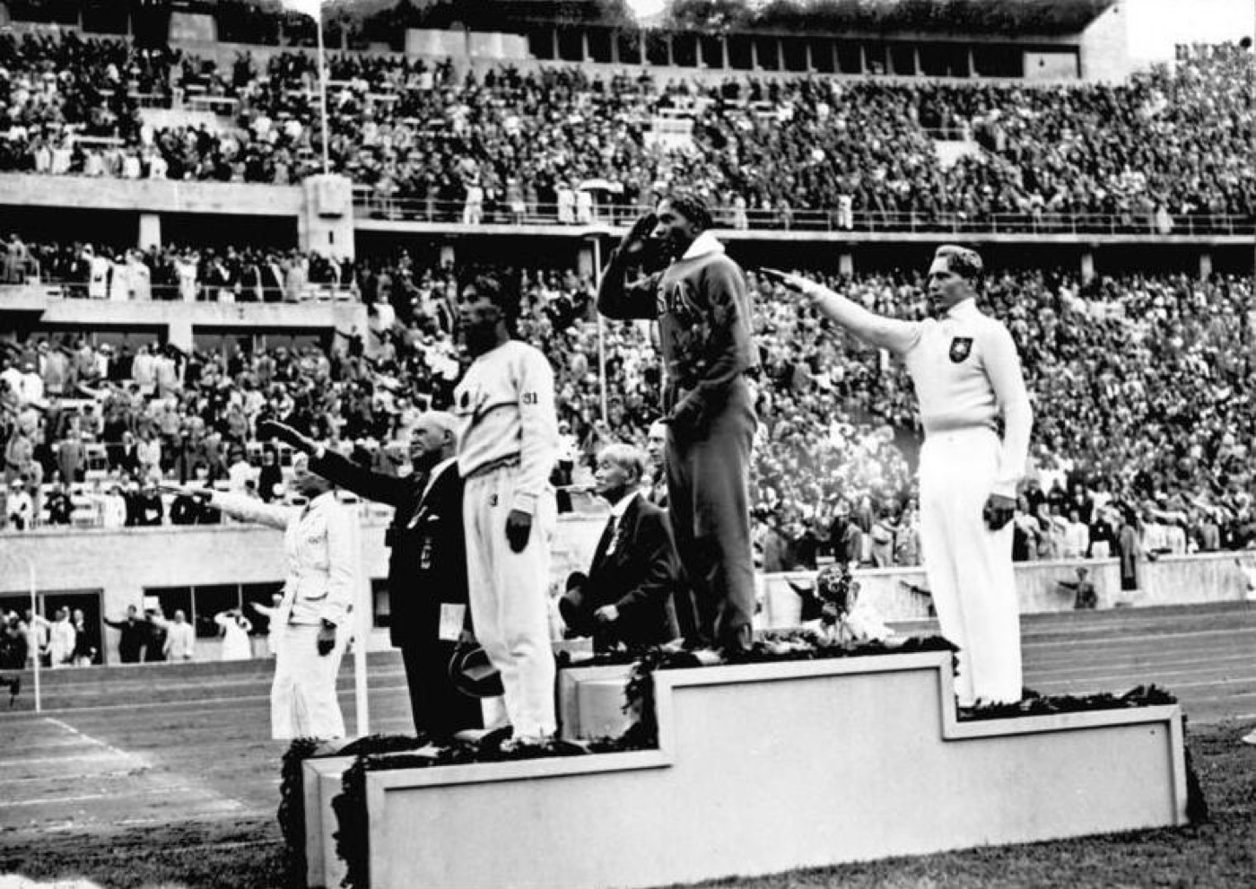Jesse Owens on the podium at the 1936 Berlin Olympics after winning the long jump.